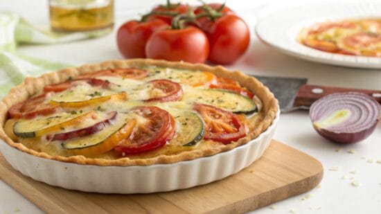 vegetable pie with tomato squash and onion toppe